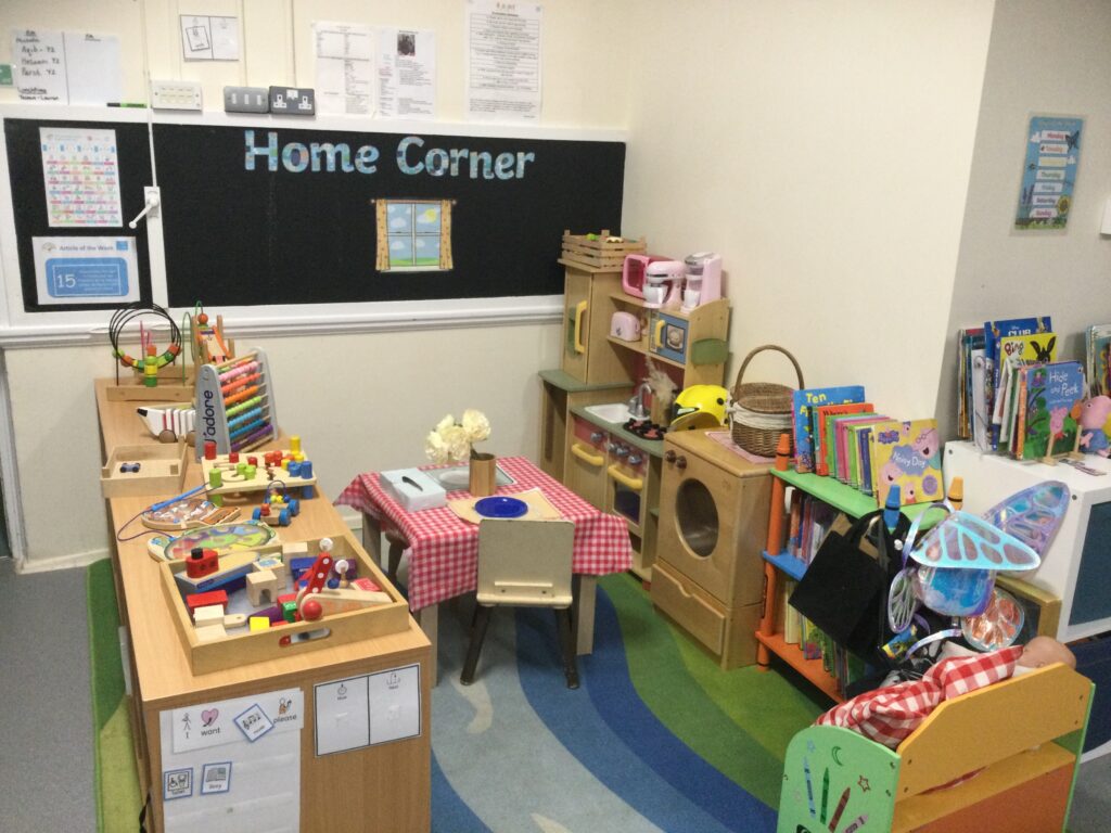 School clasroom home corner with wooden kitchen toy set.